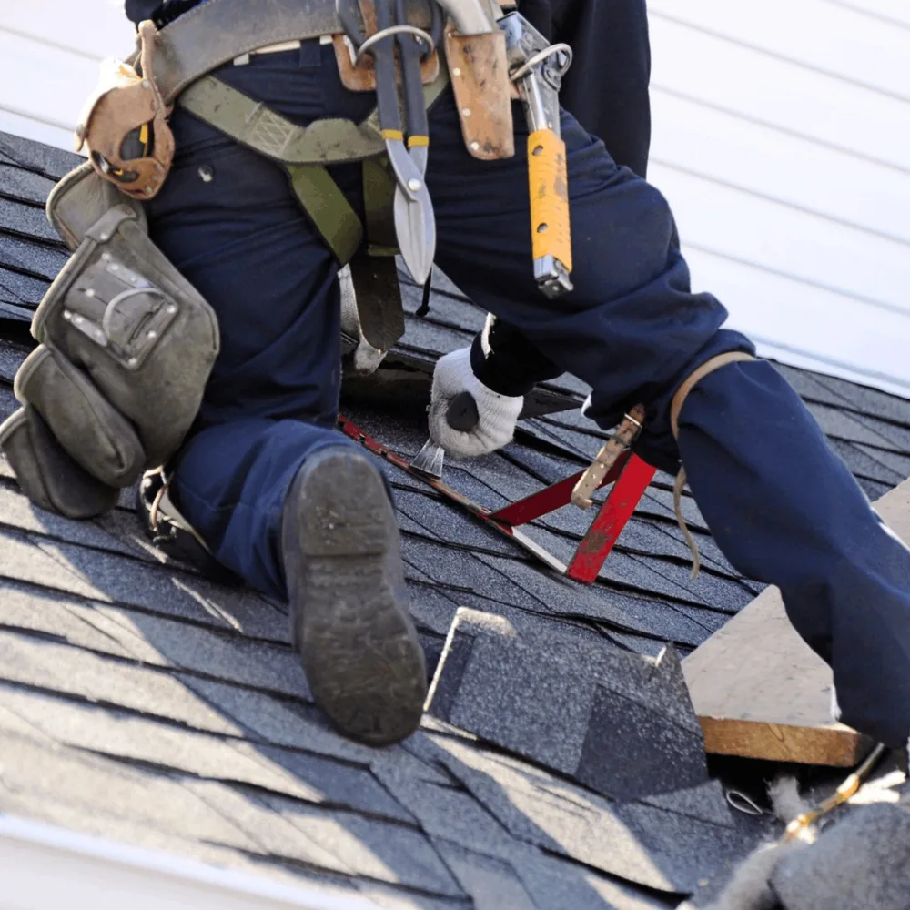 Slate roof tiles being installed over wood decking